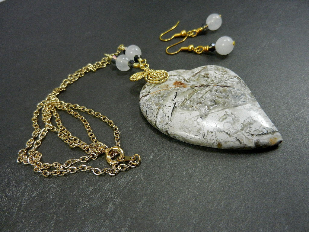 Tree Agate Heart Shaped Gemstone Pendant Gold Wire Wrapped with a White Background and Green and Grey Lines with Matching Earrings