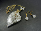 Tree Agate Heart Shaped Gemstone Pendant Gold Wire Wrapped with a White Background and Green and Grey Lines with Matching Earrings