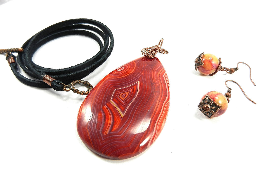 Orange Red Yellow and Cream Banded Agate Teardrop Gemstone Pendant with an Antique Copper Wire Wrapped Bail with Matching Agate Earrings and A Black Suede Necklace