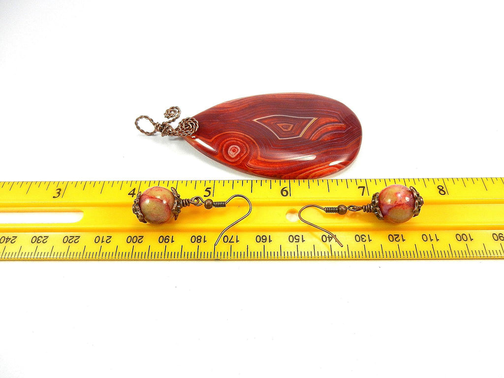 Orange Red Yellow and Cream Banded Agate Teardrop Gemstone Pendant with an Antique Copper Wire Wrapped Bail with Matching Agate Earrings and A Black Suede Necklace
