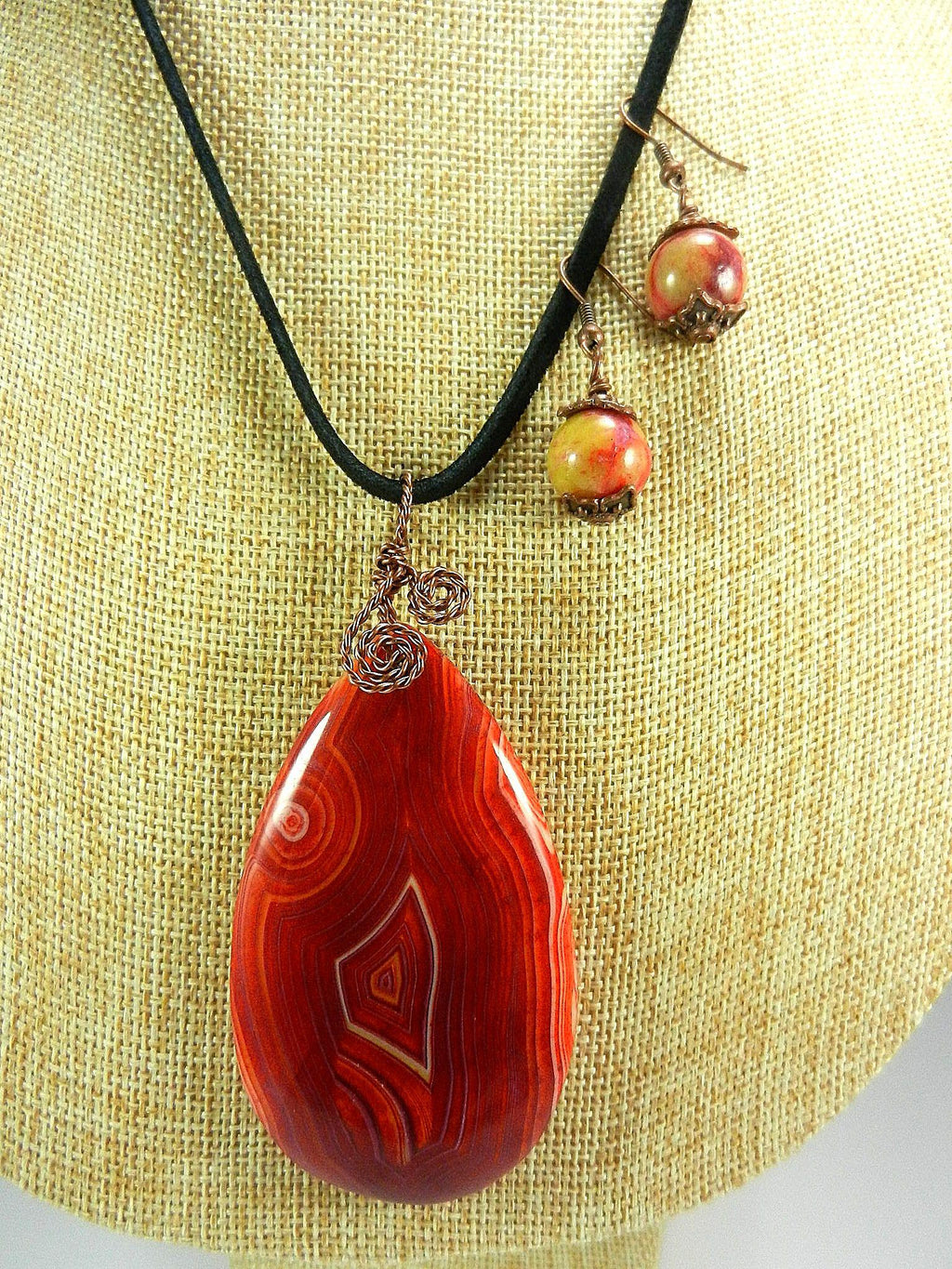Orange Red Yellow and Cream Banded Agate Teardrop Gemstone Pendant with an Antique Copper Wire Wrapped Bail with Matching Agate Earrings and A Black Suede Necklace